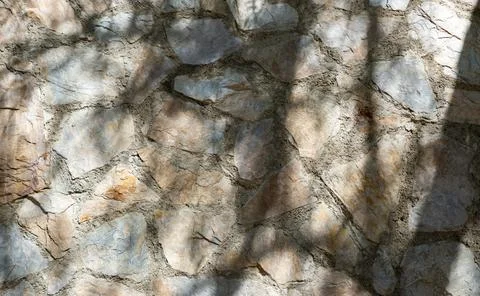 Close-up view of natural stone wall shows various shapes and colors of stones Stock Photos