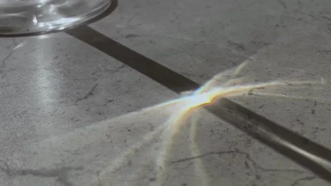 Close-up view of natural sun glare sparkle reflection on table Stock Footage 312775158