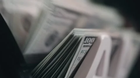 Close-up view of neatly arranged stacks of hundred-dollar bills in a cash Stock Footage 331079645
