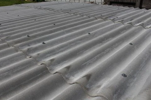 Close up view of new corrugated grey slate sheets installed on a roof with .. Stock Photos