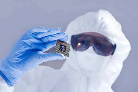 Close-up view on a new semiconductor microchip in gloved hand of computer Stock Photos