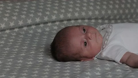 Close up view of a newborn baby lying on bed. Video stock 169639865