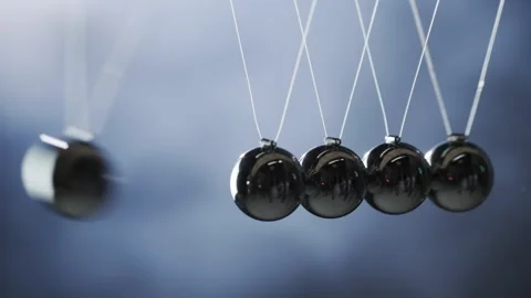 A close up view of a Newtons cradle demonstrates conservation of momentum a.. Stock Footage 335062918
