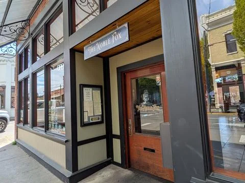 Close-up view of The Noble Fox storefront sign and glass entrance 库存照片