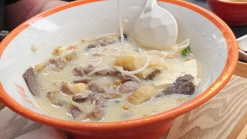 Close view of noodles and ingredients in Chinese hot pot broth, comfort foo.. Stock Footage 337323314