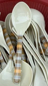 Close up view of numerous plastic spoons featuring an elegant stripe pattern  Stock Photos