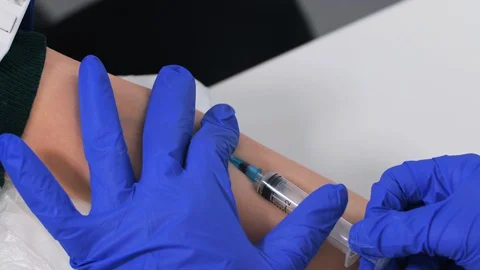 Close up view of nurse hands tries to take blood from a vein of patient Stock Footage 128372555