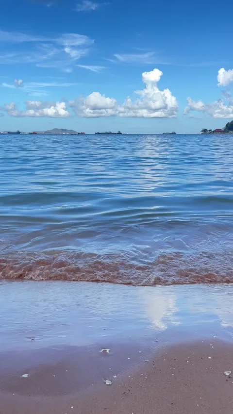 Close view of ocean waves flowing in the summer sea with sunlight reflecting on  Stock Footage 330584885