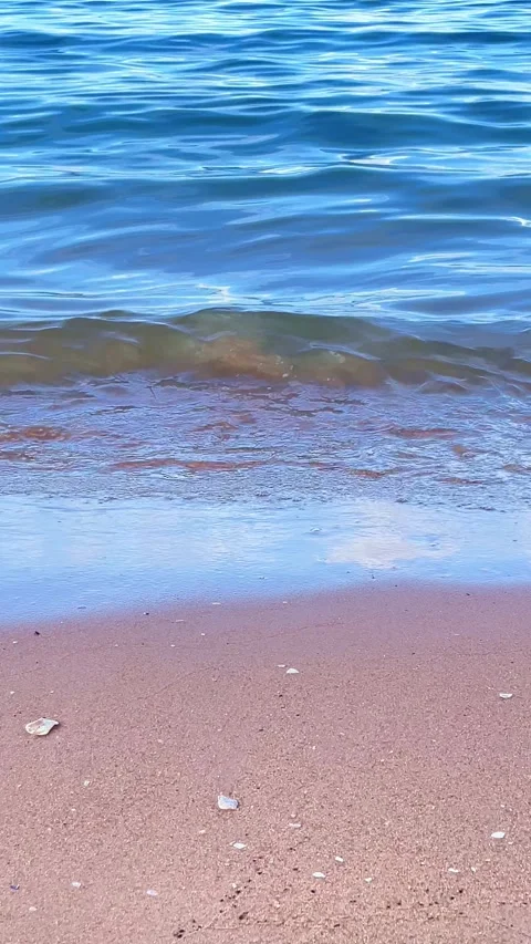 Close view of ocean waves flowing in the summer sea with sunlight reflecting on  Stock Footage 330584955