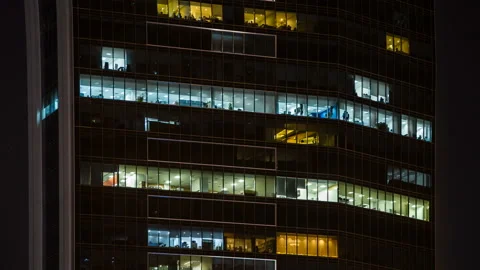 Close up view to office windows of skyscraper in downtown at night, working Stock Footage 85817556