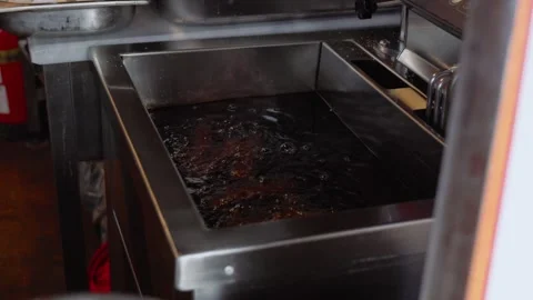 Close up view of oil boiling in a deep fryer Stock Footage 244635364