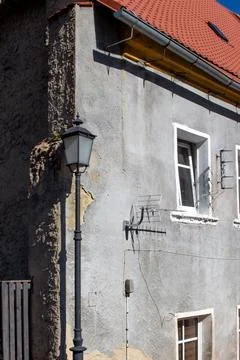 Close-up view of an old building facade with a vintage street lamp Stock Photos