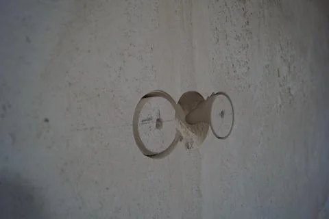 Close up view of an old electrical outlet on a white wall. Stock Photos