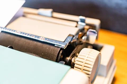 Close-up view of an old-fashioned typewriter on a wooden desk, emanating no.. Stock Photos