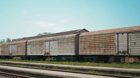 Close up view of old freight train at railway station in urban environment Stock Photos