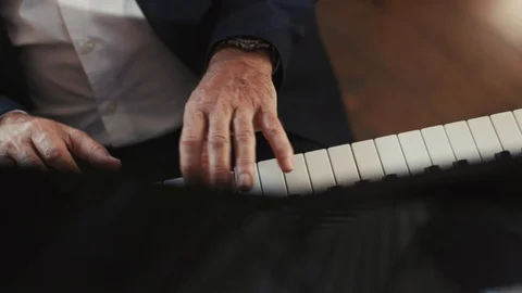 Close up view of old hands man pianist playing the fortepiano in a deserted Stock Footage 98246829