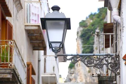 Close view of an old lantern hanging from the wall Stock Photos