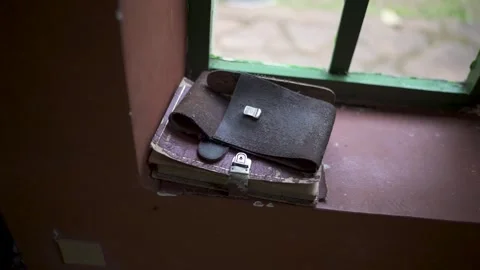 Close-up view of an old leather notebook on windowsill with vintage atmosphere. Stock Footage 318863944