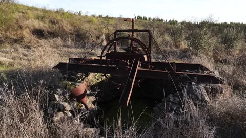Close up view of an old, rust-covered manual engine that sits beside a farm 스톡 동영상 328135205