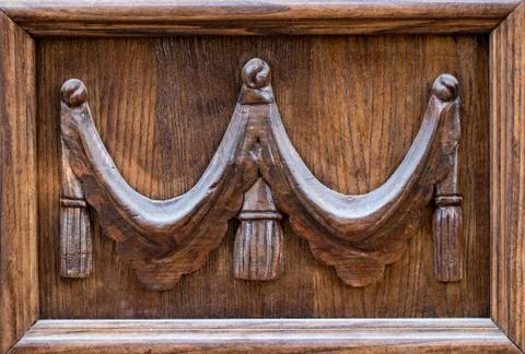Close up view of an old, rustic, massive, wooden, door with decorative carvin Stock Photos