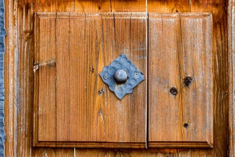 Close up view of an old, rustic, massive, wooden, door with decorative carvin Stock Photos