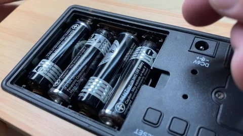 Close up view old rusty battery inside alarm clock socket. Recycle hazardous Stock Footage 248886347