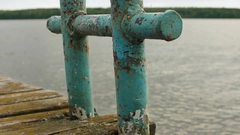 Close up view of old rusty bollard with defocused water and forest at background Stock Footage 143241635