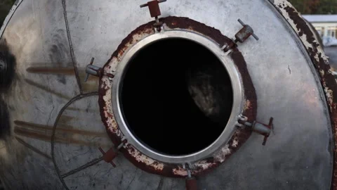 Close view of old rusty industrial metal tank with open round hatch showing corr Stock Footage 319833274
