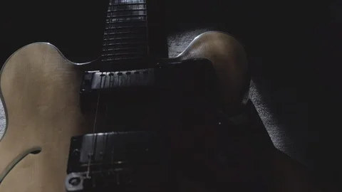 Close-up view of an old semi-acoustic hollow body guitar in light wood with t Stock Footage 123971218