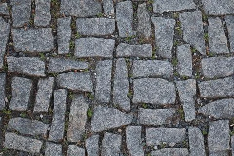 Close-up view of old stone pavement with irregular grey stones Stock Photos
