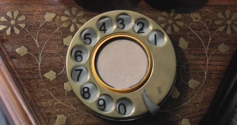 Close-up view on an old style telephone dial. Rotating numbers by finger. Vídeo Stock 154723800