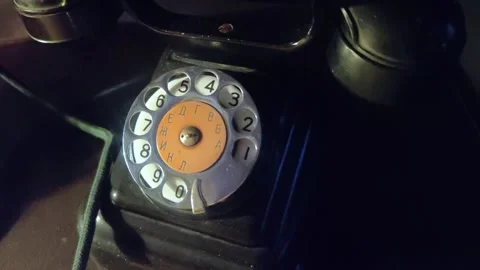 Close-up view on an old style telephone dial. Antique white telephone. Video stock 293298552