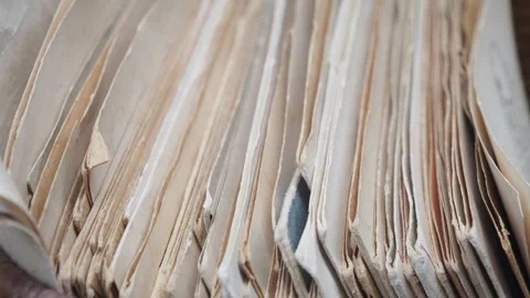 Close up view of old wrinkled sheets of paper forming a stack inside a wick.. Stock Footage 332578462