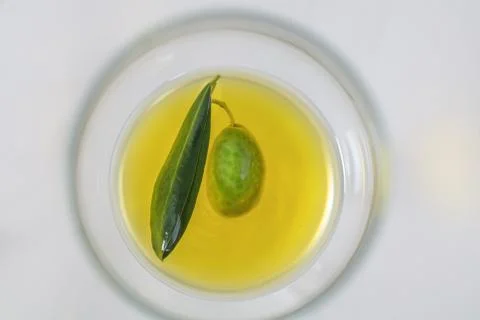 Close up view of olive and extra virgin olive oil with olive leaf on white ba Stock Photos