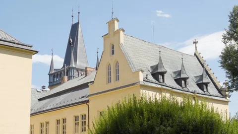 A close view of one side of an old, historic castle, surrounded by tress and Stock-Footage 122769601