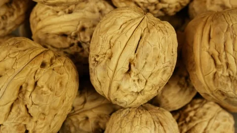 Close-up view of one walnut on rotating pile of nuts. Stock-Footage 181598019