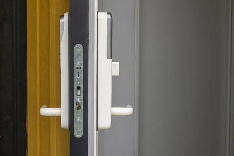 Close up view of open front door of villa with white digital lock. Sweden. Stockfoto's
