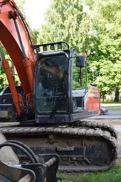 Close-Up View of Orange Crawler Excavator Cab at Construction Area Stock Photos