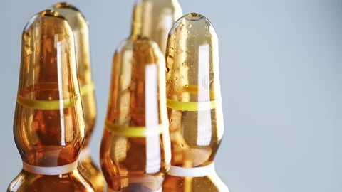 Close-up view of orange glass vials arranged on a clean surface Stock Footage 330592815