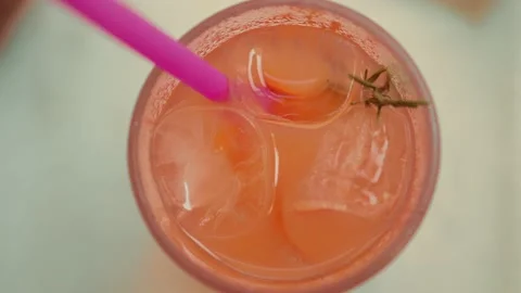 Close up view of an orange lemonade with ice in transparent glass Stock Footage 204998146