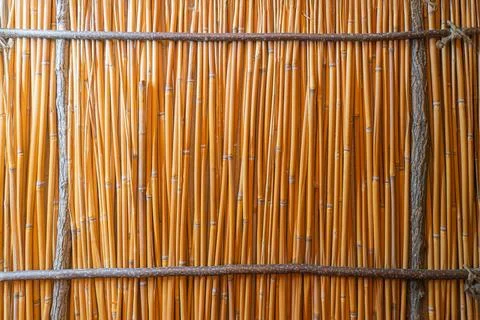 Close-up view of orange woven material possibly bamboo or rattan, rough tex.. Stock Photos