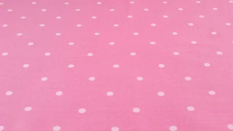 Close-up view of the orchid pink with white polka dots cotton fabric rotated  Stock Footage 293883300