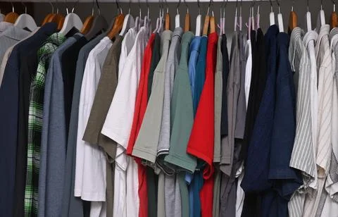 A close-up view of a organized wardrobe featuring a varied selection of men c Stock Photos