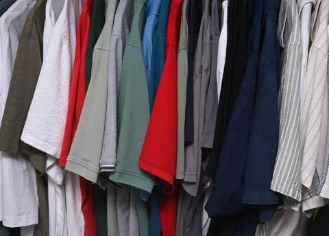 A close-up view of a organized wardrobe featuring a varied selection of men.. Stock Photos