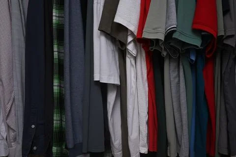 A close-up view of a organized wardrobe featuring a varied selection of men c Stock Photos