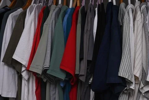 A close-up view of a organized wardrobe featuring a varied selection of men c Stock Photos