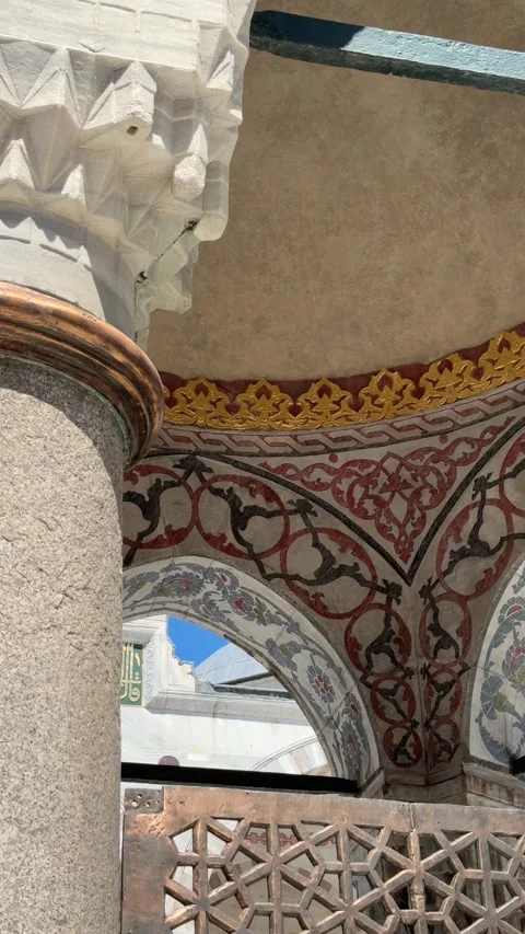 Close-up view of ornate painted arches with floral motifs and golden details in Stock Footage 340898584