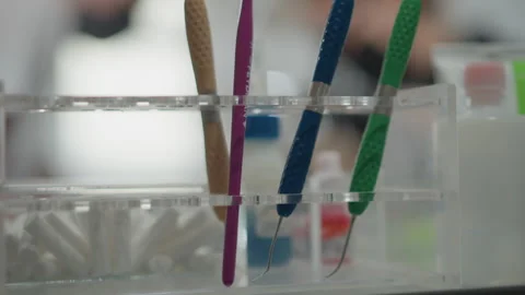 Close up view of orthodontic dental instruments including colored tools arranged Stock Footage 345833693
