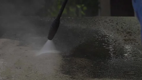 Close up view outdoor floor cleaning with high pressure water jet in house by Stock Footage 157007340