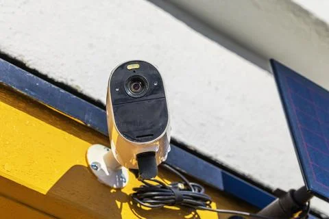 Close up view of outdoor security camera with solar panel installed Stock Photos